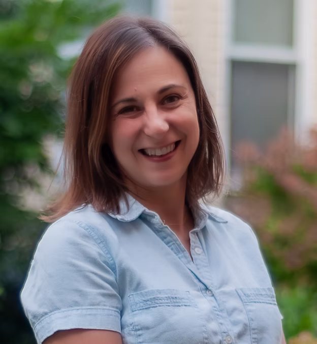 Smiling woman in casual shirt.